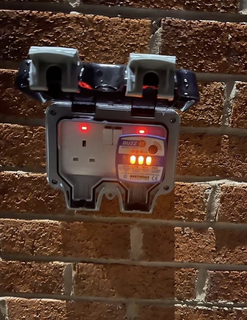 Outdoor socket with a tester plugged in